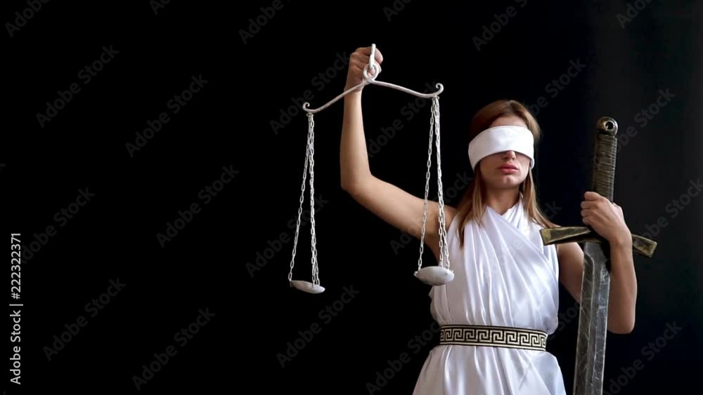 Themis with sword and scales is an ancient Greek goddess of justice on a black background. concept idea for advocates and lawyers Themis with sword and scales is an ancient Greek goddess of justice on a black background. concept idea for advocates and lawyers
