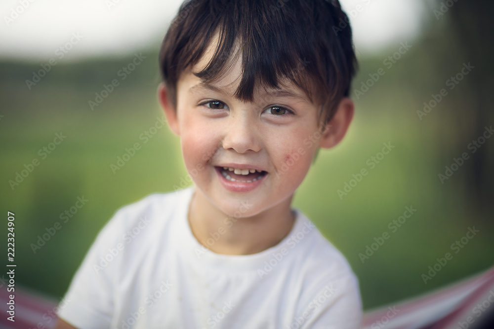 boy looking at the camera outdoors boy looking at the camera outdoors