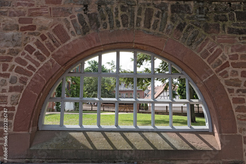 Monastery wall with iron lattice window  Seligenstadt  Hesse  Germany