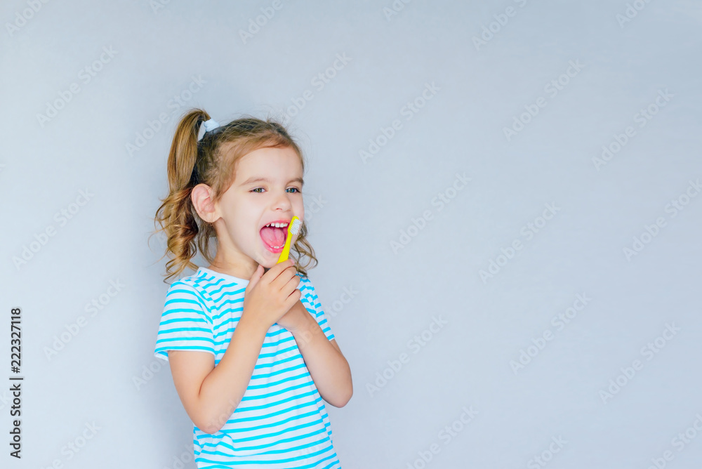 Beautiful baby girl brushing her teeth. Baby girl brushing her teeth and singing a favorite song. Health care, dental hygiene, people and beauty concept. Mockup, free spase. Selective focus. Beautiful baby girl brushing her teeth. Baby girl brushing her teeth and singing a favorite song. Health care, dental hygiene, people and beauty concept. Mockup, free spase. Selective focus.