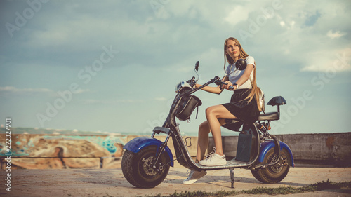 Young Woman Riding Electro Scooter On Country Road
