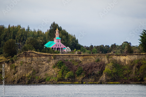 Tipical wood made church in Chiloe island, Chile. Patagonia, view crossing the channel photo