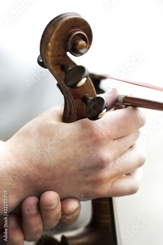 Close up of a string musical instrument holding a hand