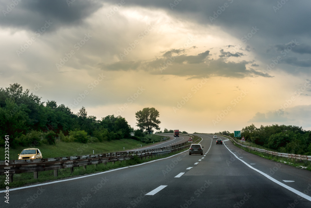 Highway Traffic at sunset through pastoral landscape