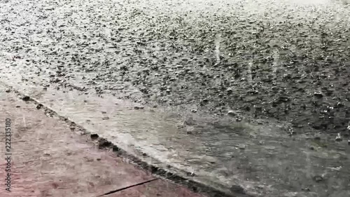 Torrential rain falling from a storm flooding a city street in South Beach, Miami, Florida