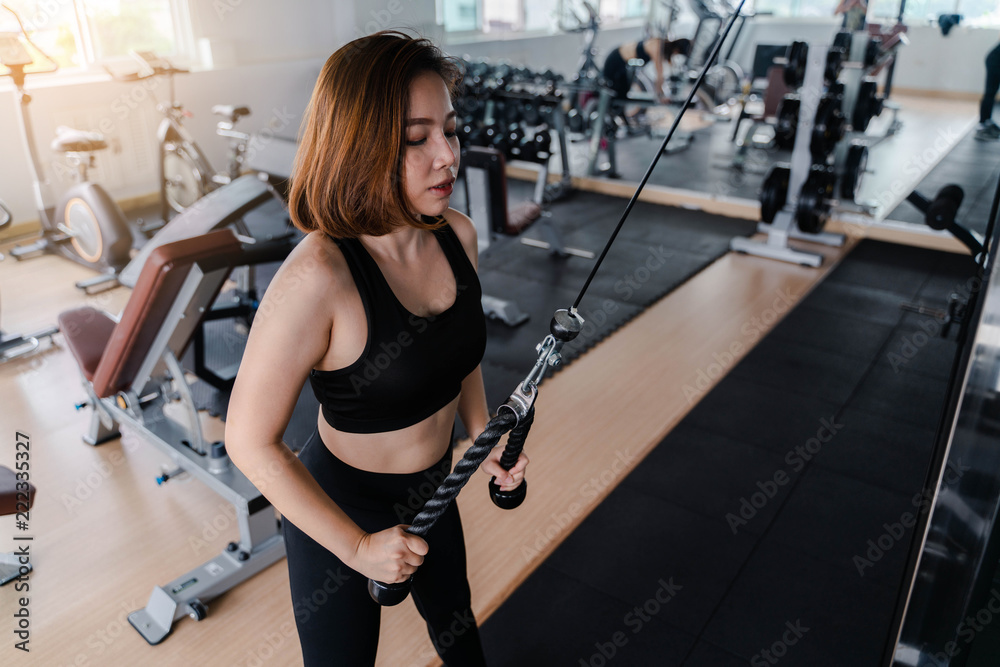 fitness woman doing exercises in the gym Concept of healthy lifestyle in the gym fitness woman doing exercises in the gym Concept of healthy lifestyle in the gym