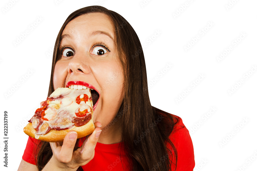 Young pretty girl eats piece of pizza with tomatoes, salami and cheese isolated on a white background.