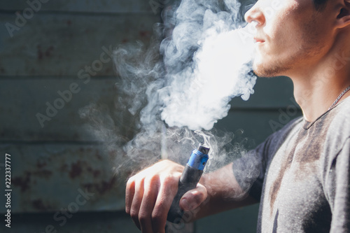 vape man. the modern young person produces clouds of vapor