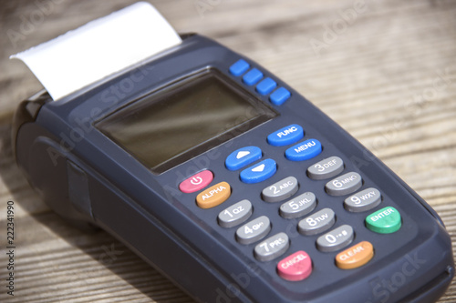 POS payment terminal on wooden background