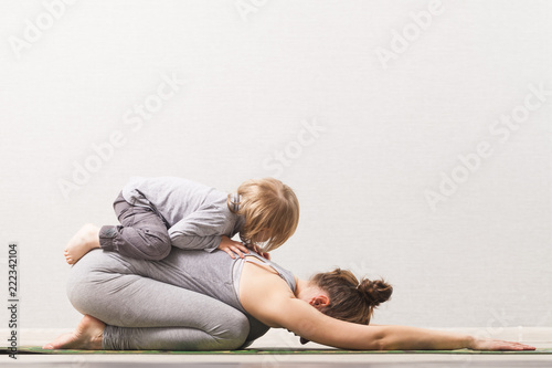 woman mom practicing yoga with her child