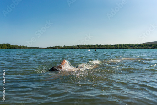 Man swimming in the Störmthaler Lake near Leipzig