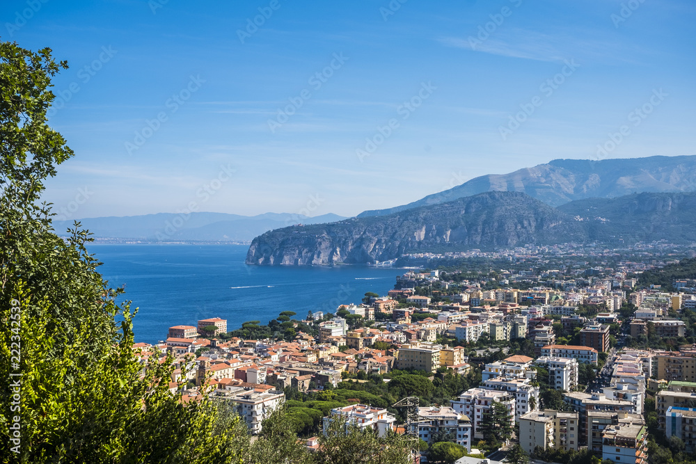 aerial view from the mountains of Sorrento in Italy, vacation place and city on the Naples coast. Mountains and Vesuio vulcan in background