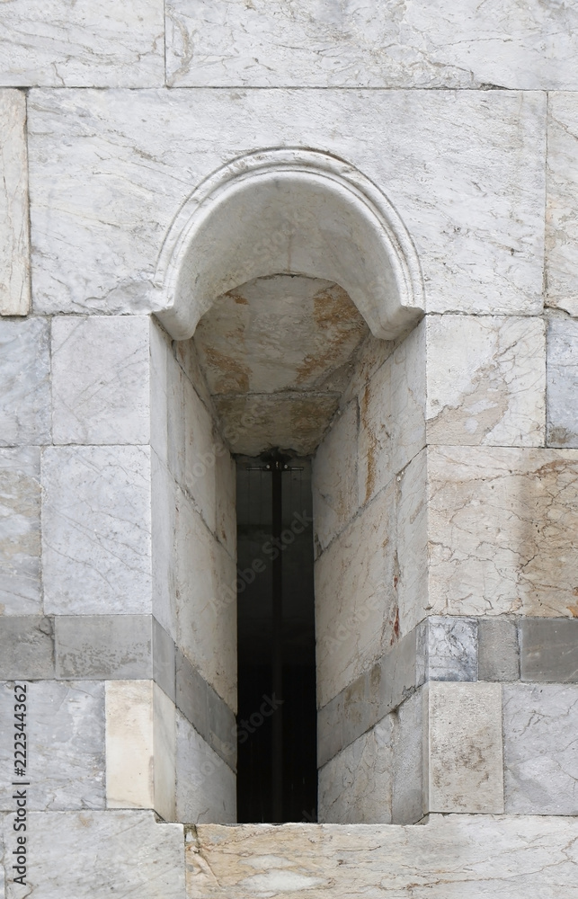 Small window on marble facade