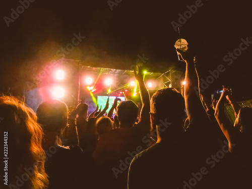 Obraz na płótnie The party, concert concept. Crowd raising their hands and enjoying great rock festival. blur bokeh for background. w salonie