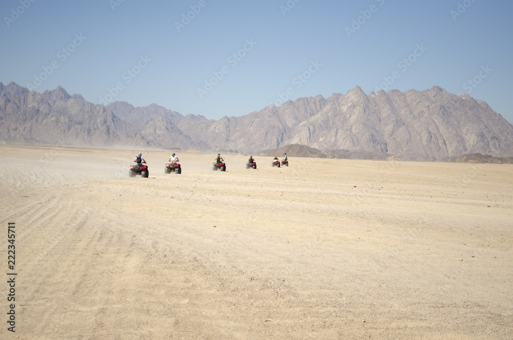 a group of people on quad bikes in the desert a group of people on quad bikes in the desert