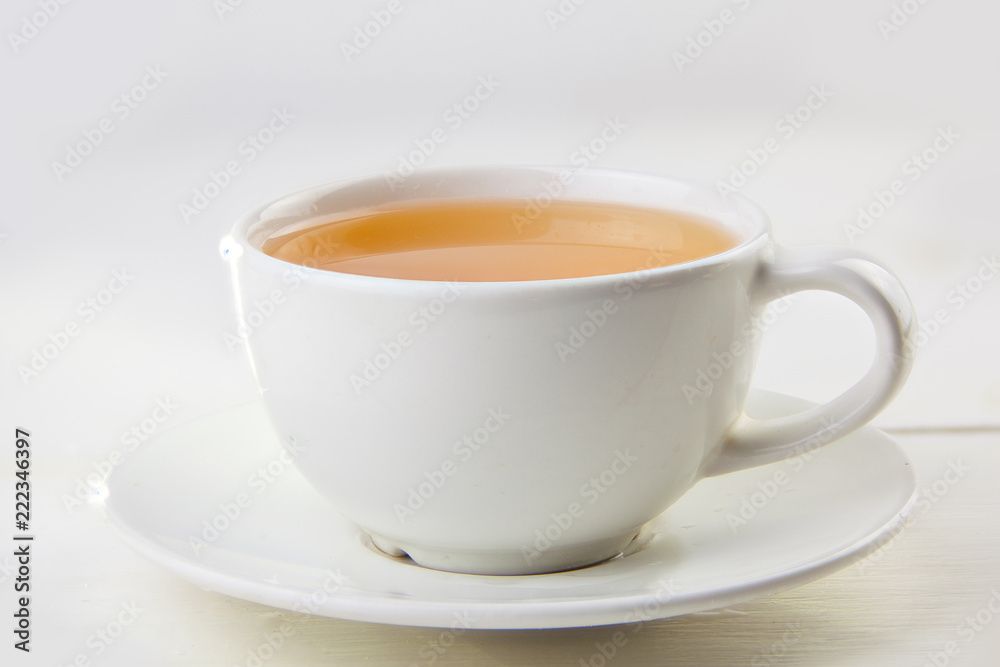 porcelainl cup with green tea on table porcelainl cup with green tea on table