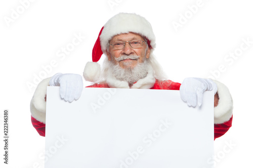 Christmas. Good Santa Claus in white gloves holds a blank white cardboard. Place for advertising, for text, empty space. Copy-paste. Isolated on white background.