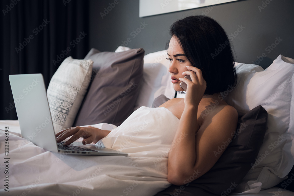 Beautiful woman lying in bed and making a phone call. Young girl using her laptop at home. Beautiful woman relaxing at home. Beautiful woman lying in bed and making a phone call. Young girl using her laptop at home. Beautiful woman relaxing at home.