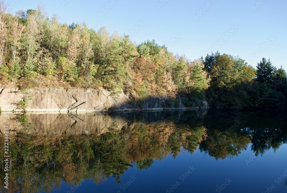 Forest and the sky reflected on the mirror lake Forest and the sky reflected on the mirror lake