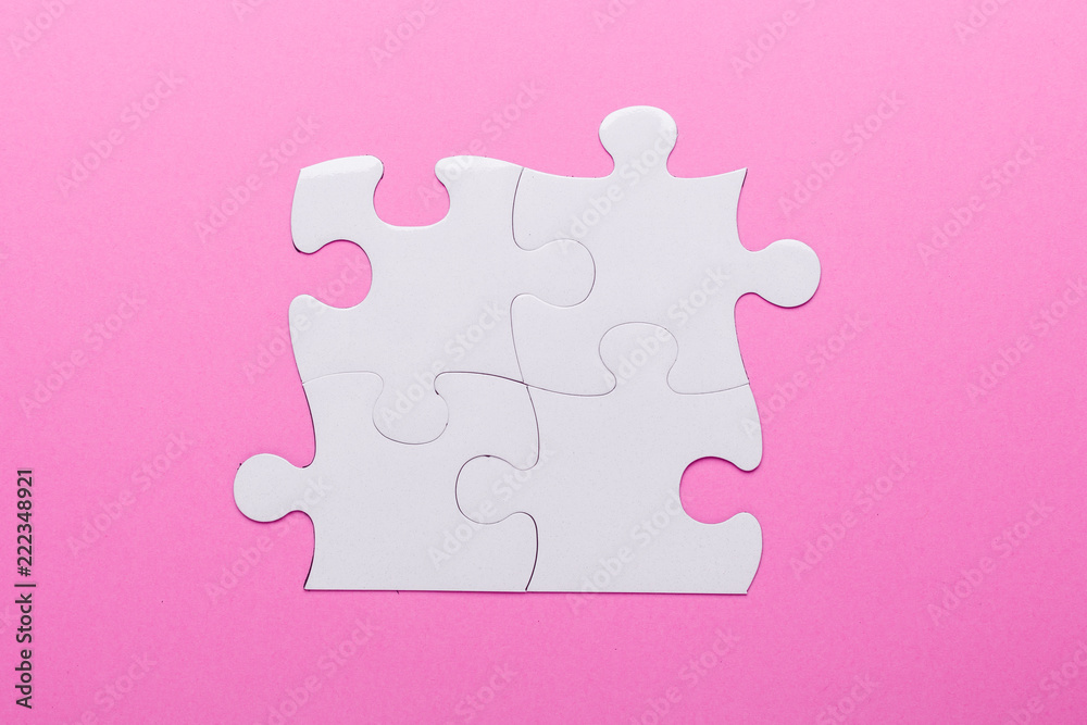 White puzzle on pink background. Top view White puzzle on pink background. Top view