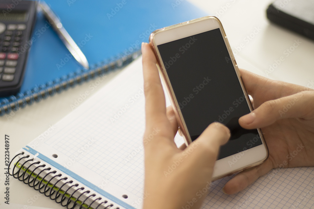 Woman using a smartphone with black screen