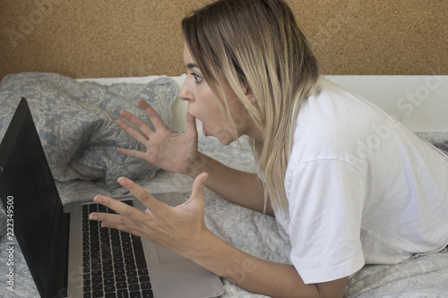 Excited woman reading content online photo