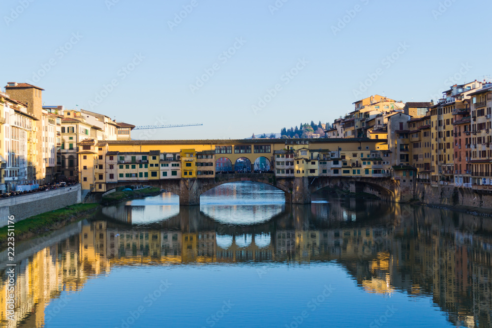 Famous bridge Ponte Vecchio over Arno river at sunset in Florence, Tuscany, Italy