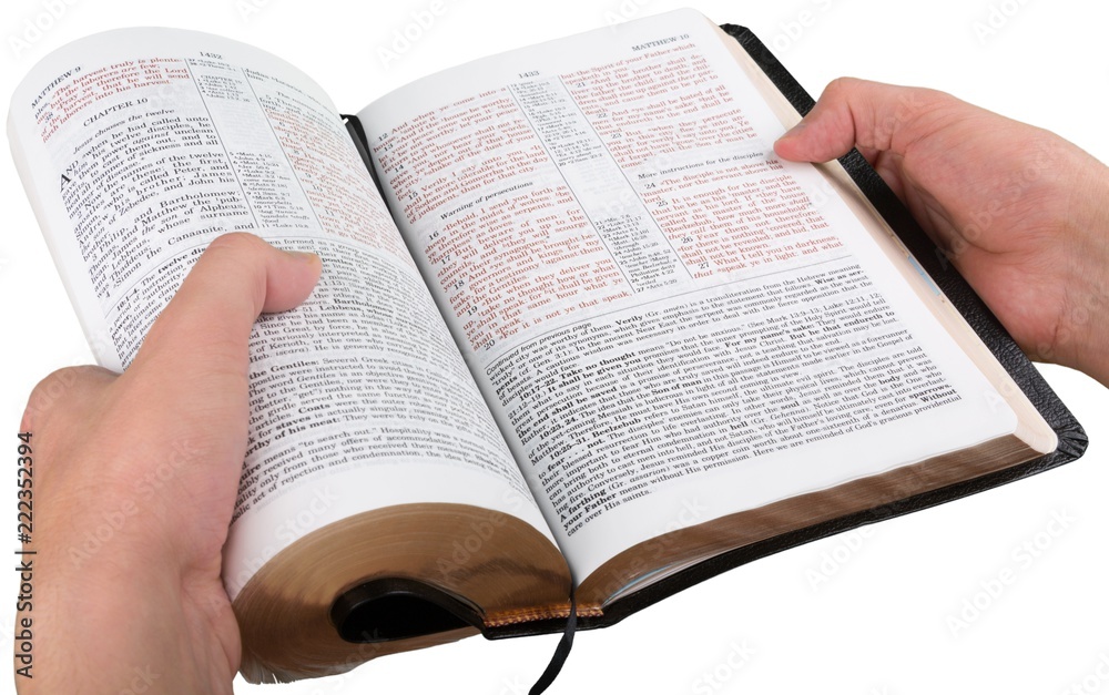 Fototapeta premium Hands Holding an Open Bible