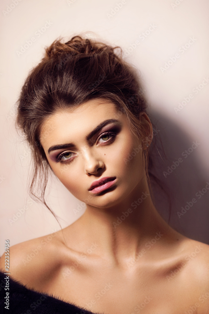 Naklejka premium Portrait of beautiful young brunette woman with makeup
