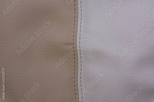 Part of a leather bag of beige and white color