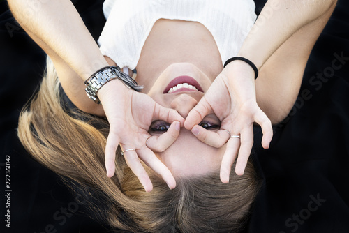 Beautiful young girl making gestures with her hands.