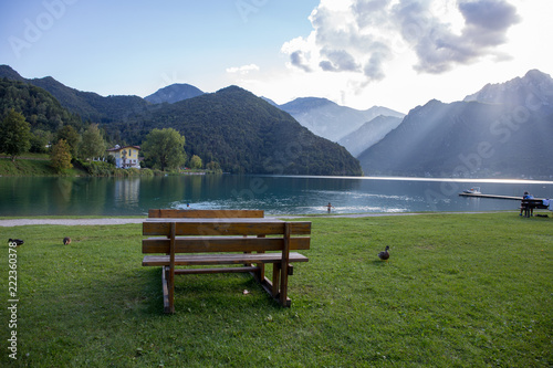 picnic tables and benches in the green on the shore of Ledro Lake 