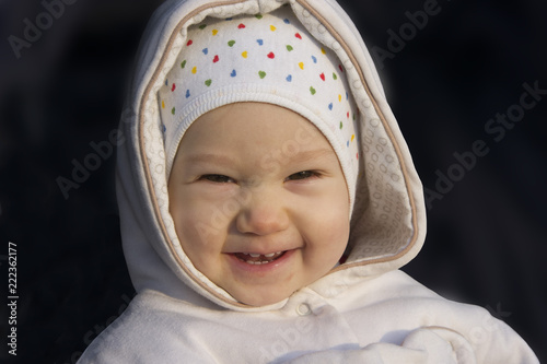 Smiling baby in hood portrait