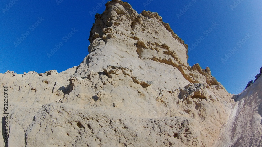 cliff edge with mountain on blue sky background
