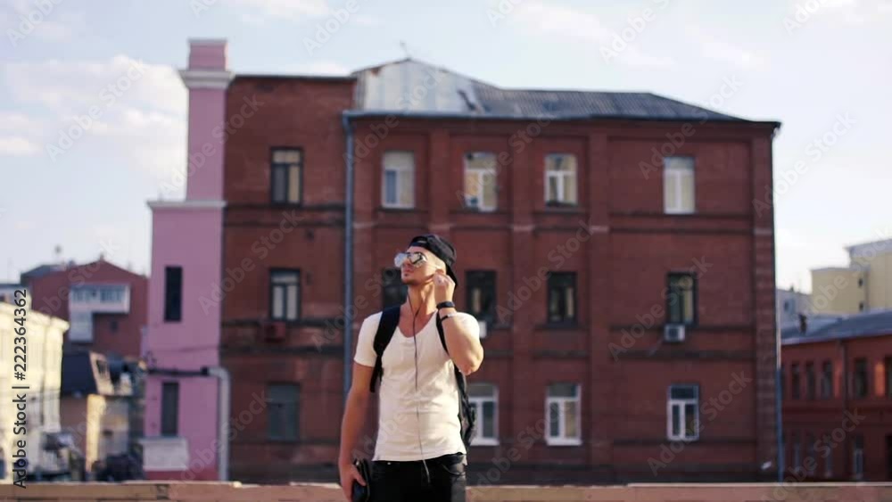 Young man dancing in headphones in the city Young man dancing in headphones in the city
