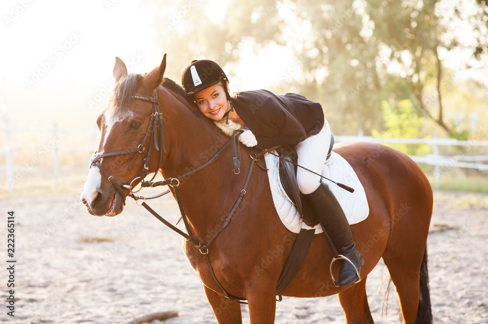 Fototapeta premium A beautiful girl rider walks with a horse. Horse theme