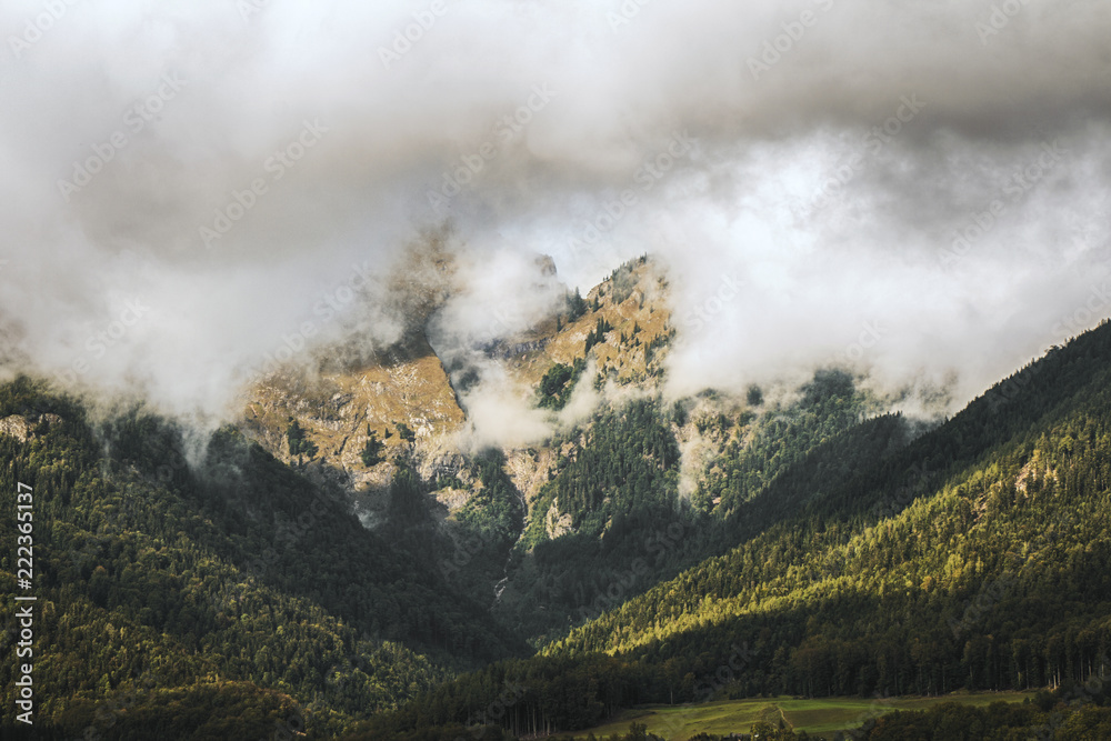 Photo of sunny misty mountains and valleys in austrian Alps