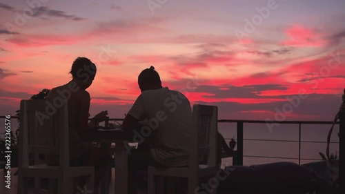 Romantic couple dinner in viewpoint restaurant withamazing colorful sunset
