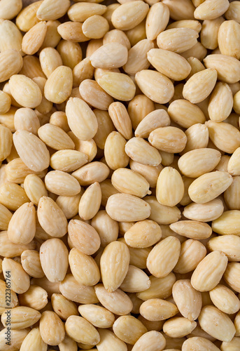 peeled almonds on wooden surface
