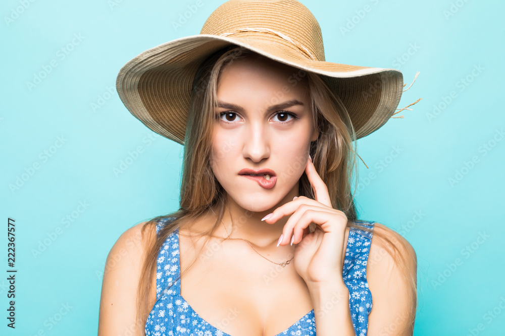Face portrait of woman in straw hat isolated on blue background Face portrait of woman in straw hat isolated on blue background