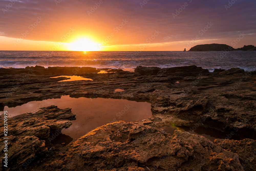 Wonderful sunset while cloudy sky reflects on sea water puddle Wonderful sunset while cloudy sky reflects on sea water puddle