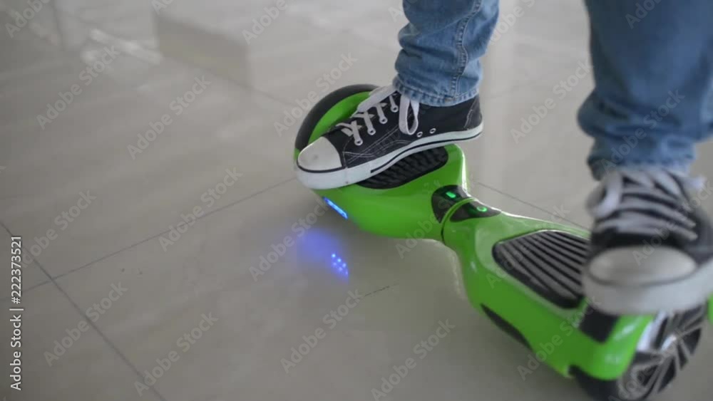 Man acrobat balancing motorized scooter - shows tricks