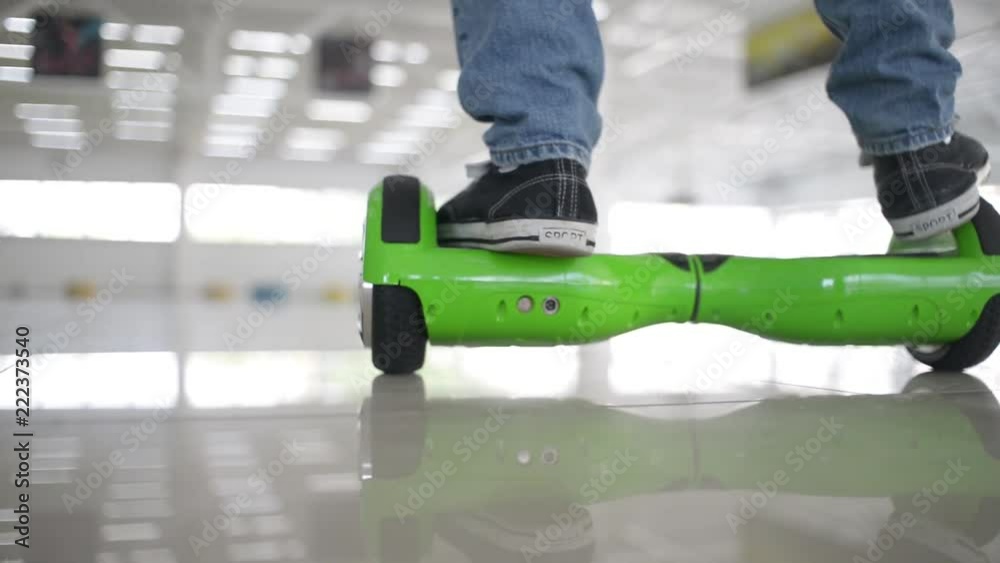 Man acrobat balancing motorized scooter - shows tricks