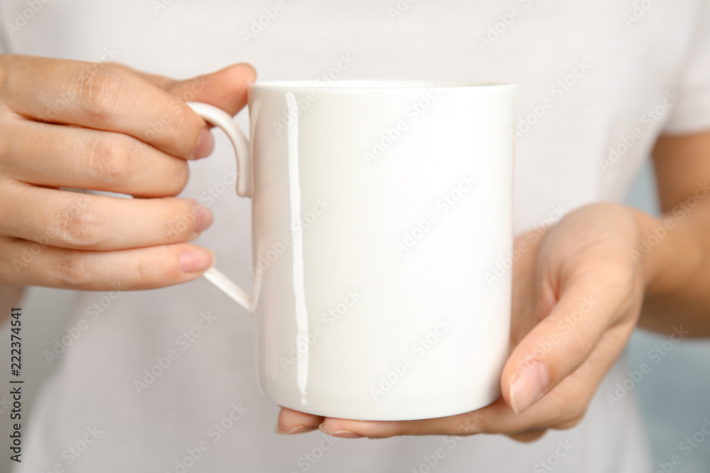 Woman holding ceramic cup, closeup. Mock up for design Woman holding ceramic cup, closeup. Mock up for design