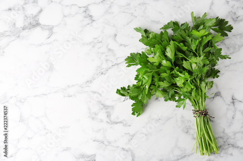 Fresh green parsley and space for text on marble background, top view