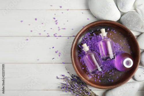 Fototapeta Naklejka Na Ścianę i Meble -  Flat lay composition with natural herbal oil and lavender flowers on wooden background. Space for text