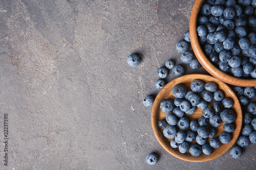 Flat lay composition with juicy blueberries and space for text on color table