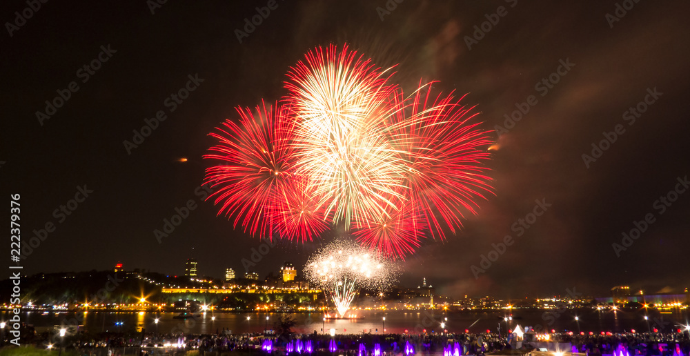 White and red fireworks over the Saint-Lawrence River near Quebec City during a Canadian summer festival. White and red fireworks over the Saint-Lawrence River near Quebec City during a Canadian summer festival.