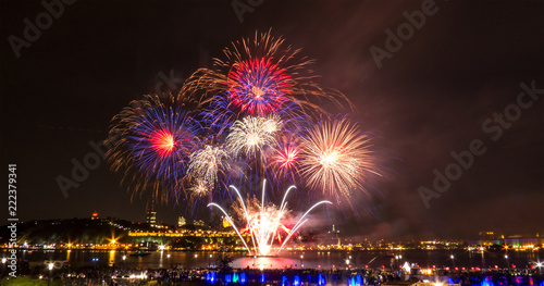 Blue, red, and white fireworks during a summer festival in Quebec City, Canada.