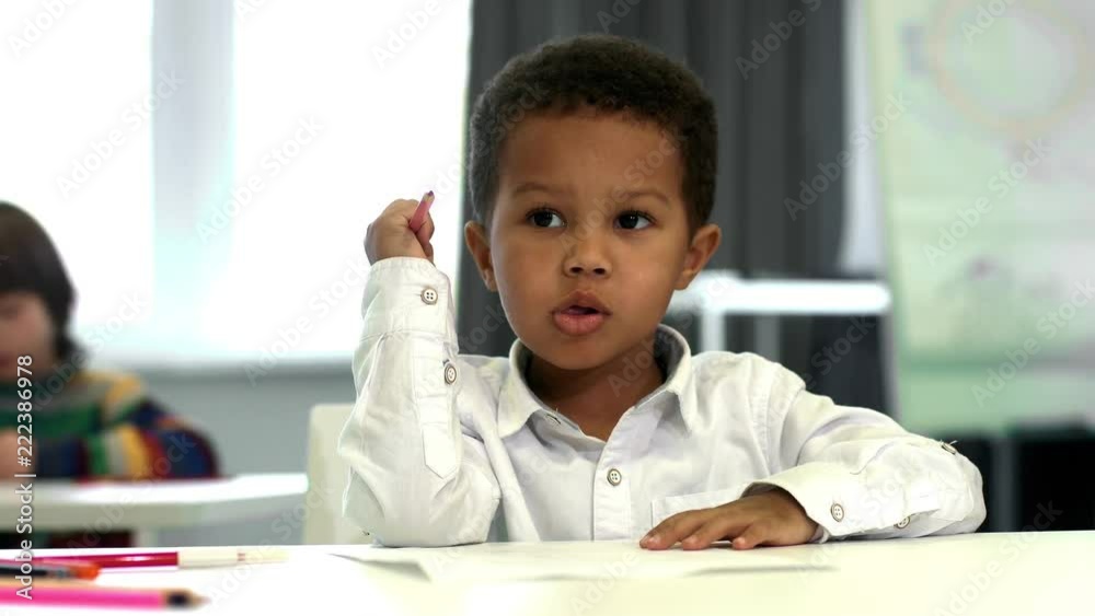 Adorable little African boy drawing at school Adorable little African boy drawing at school